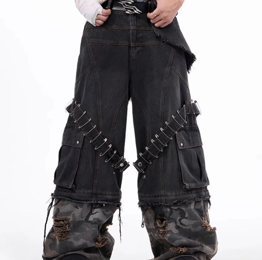 Men's grey jeans with camouflage splicing design and pin and ribbon details on the legs.