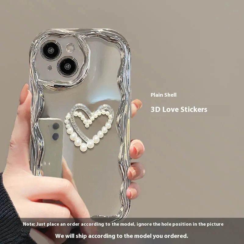 Silver grey silicone phone case for iPhone 14 Pro Max with three-dimensional heart and pearl chain bracelet.