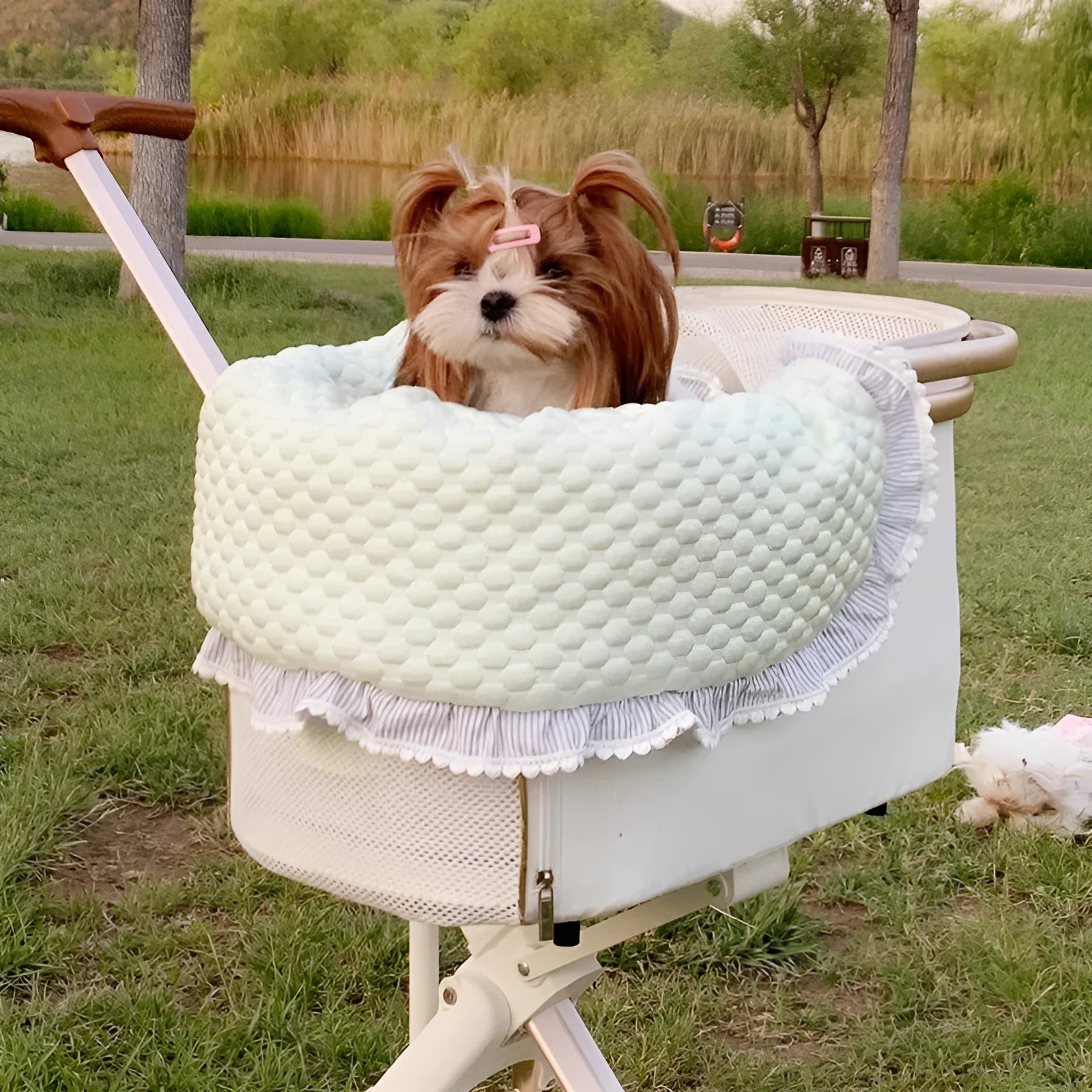 A green grey striped towel, cushion, and pillow set for a pet stroller, shown removed and ready for washing.