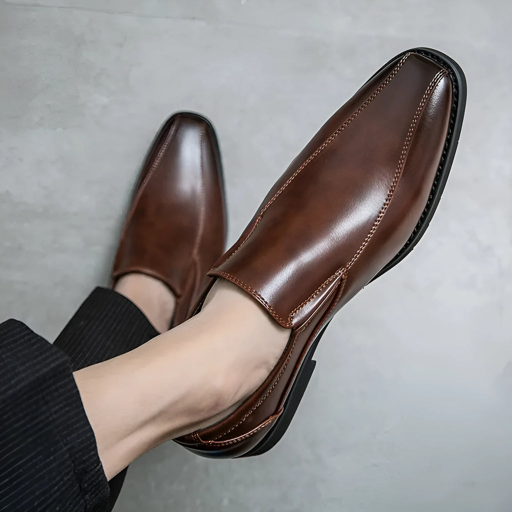 Men's black patent leather pointed toe shoes with a flat rubber sole and leather lining.