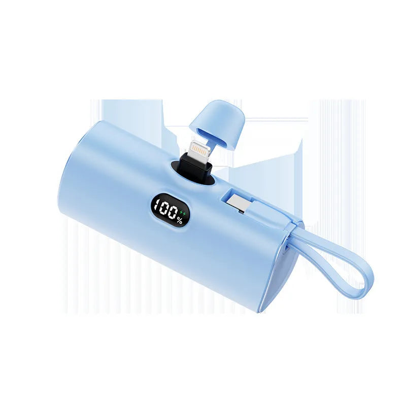 Capsule shaped digital display wireless power bank in multiple colours showing its compact size and built-in plug.