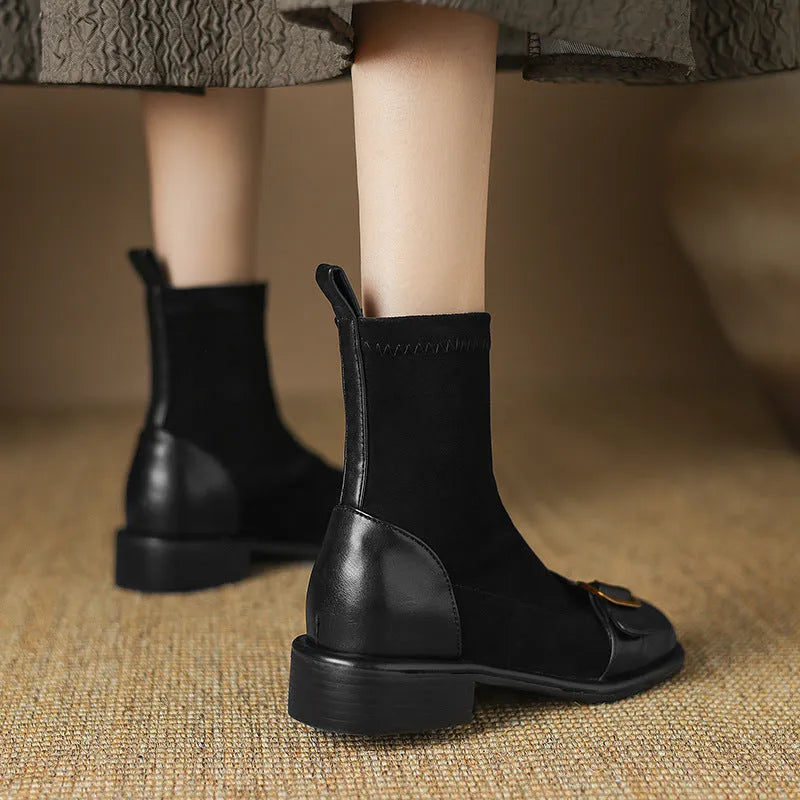 Black women's ankle boots with lace-up front and belt buckle stitching detail.