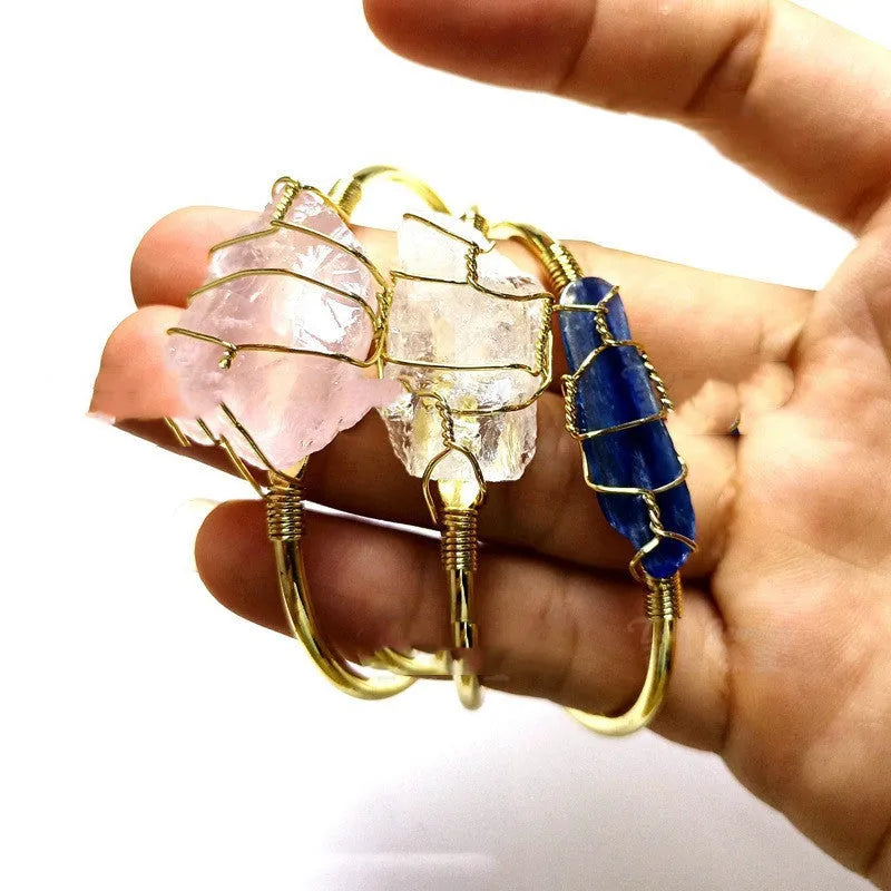 Unisex geometric bracelet made from rough natural crystals with gold metal winding.
