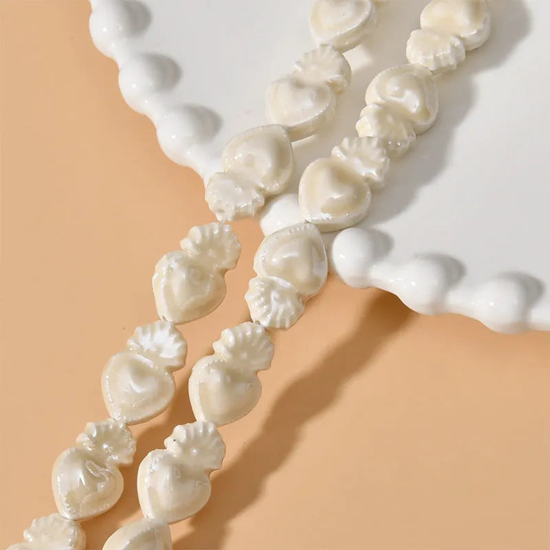 Love heart torch-shaped ceramic beads, about 10 x 15mm with 1.7mm straight hole, in cream white and other colours.