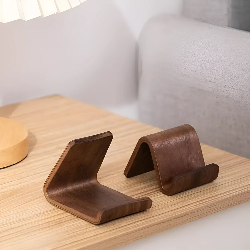 Walnut wooden mobile phone bracket on a desk, with a smartphone placed in the stand