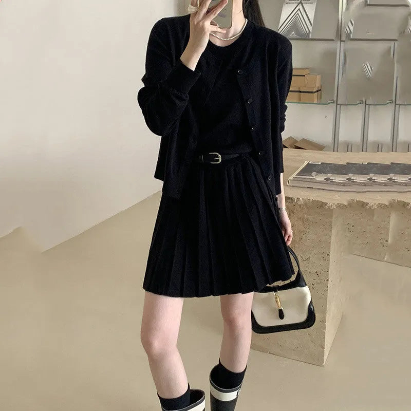 Grey art retro knitted two-piece set with 3D pattern, featuring a pleated vest skirt with belt and a V-neck long-sleeve cardigan.
