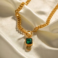Gold electroplated titanium steel necklace with geometric pendant and emerald zircon stone