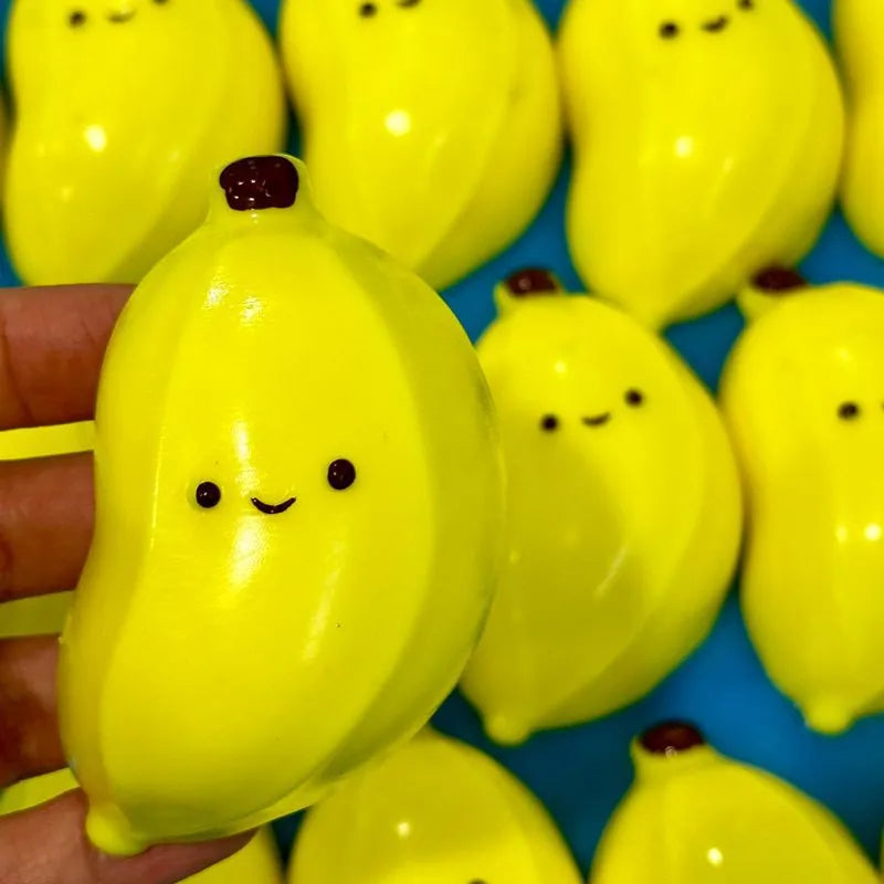 Chubby banana squeezing toy in yellow TPR shape with soft texture on plain background