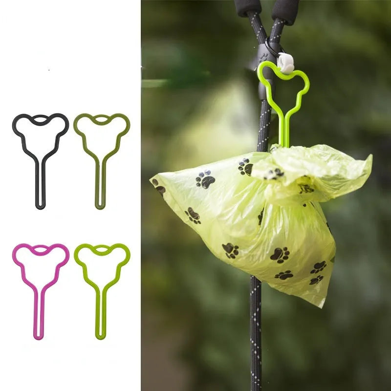A dog poo bag holder with a hands-free clip and black Velcro strap attached to a leash.