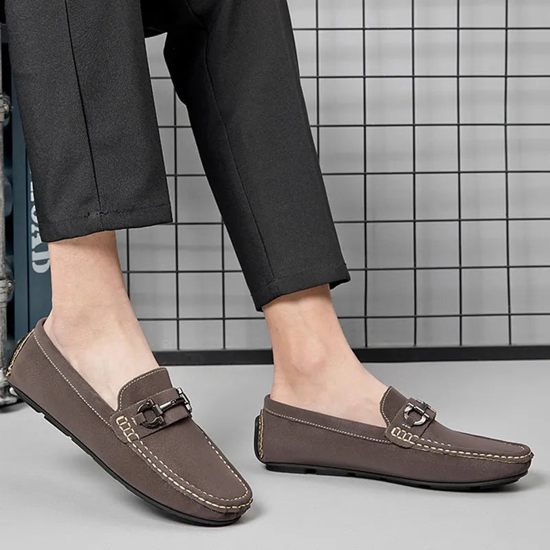 Men's beige cowhide leather slip-on loafers with round toe and rubber sole on a neutral background.