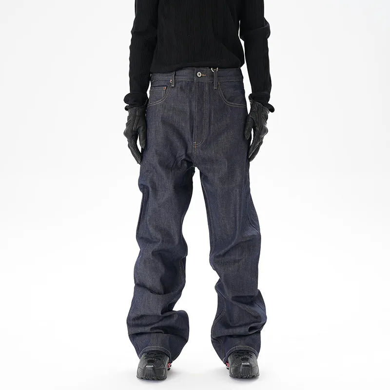 Man wearing dark blue loose fit straight leg denim jeans.