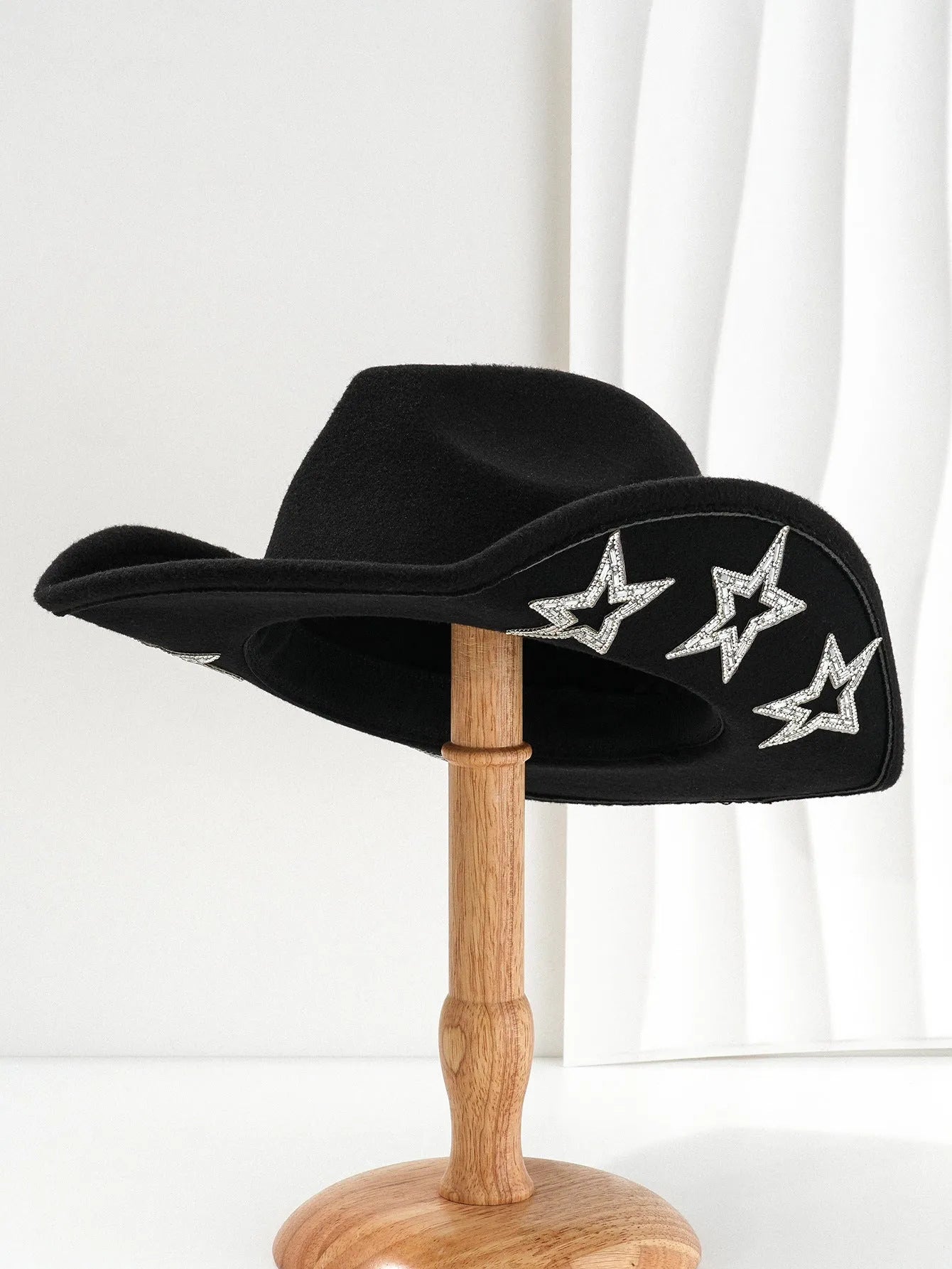 Beige woven polyester western top hat with a conical crown and a hexagonal star decoration on the front.
