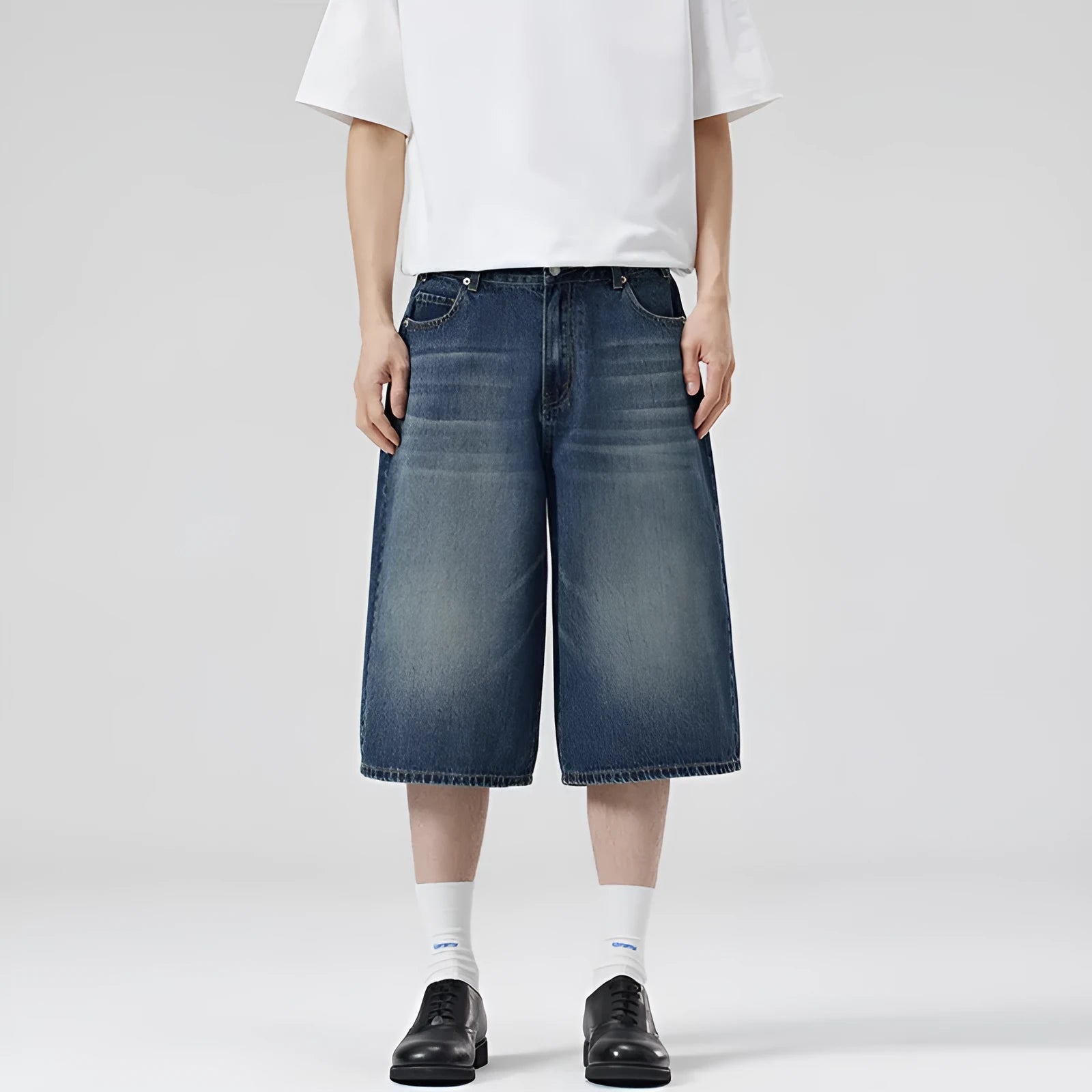 A pair of light blue denim shorts with a loose straight leg and cropped length on a neutral background.