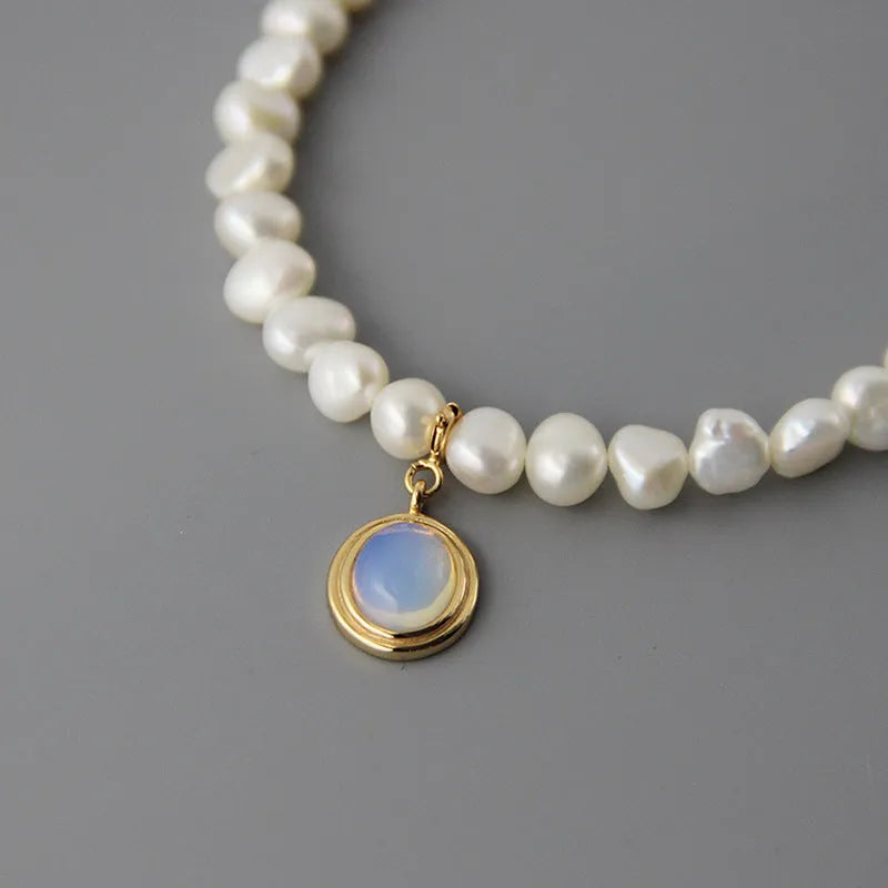 Sterling silver necklace with geometric pearl pendant showing adjustable length chain