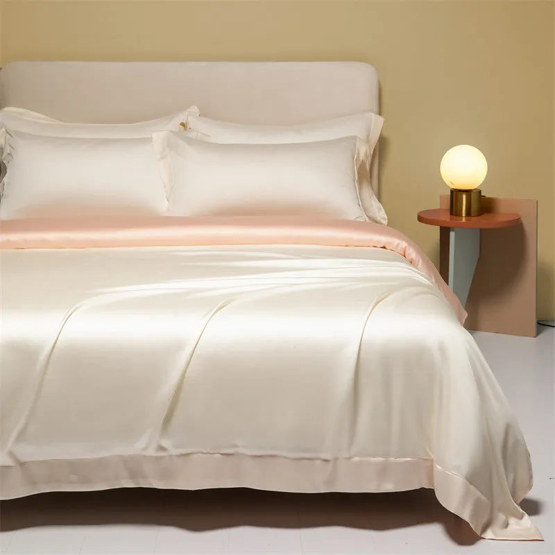 Luxury Lenzing Tencel bedding set in Aurora Blue on a bed, showing quilt cover, sheet, and two pillowcases.