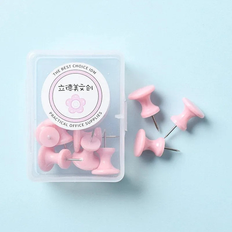 Plastic push pins in cherry blossom pink, mint green, and lavender colours, showing both large and small sizes on a white surface