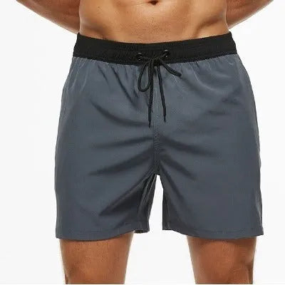 Men's blue fitness shorts with a drawstring waistband and a side zipper pocket.