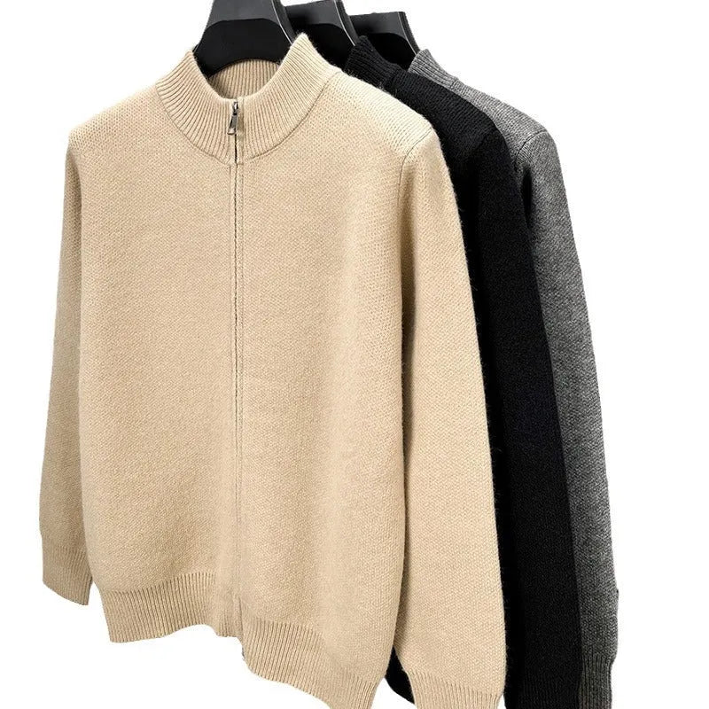 Man wearing a thick grey stand collar knitted cardigan with a zipper front.