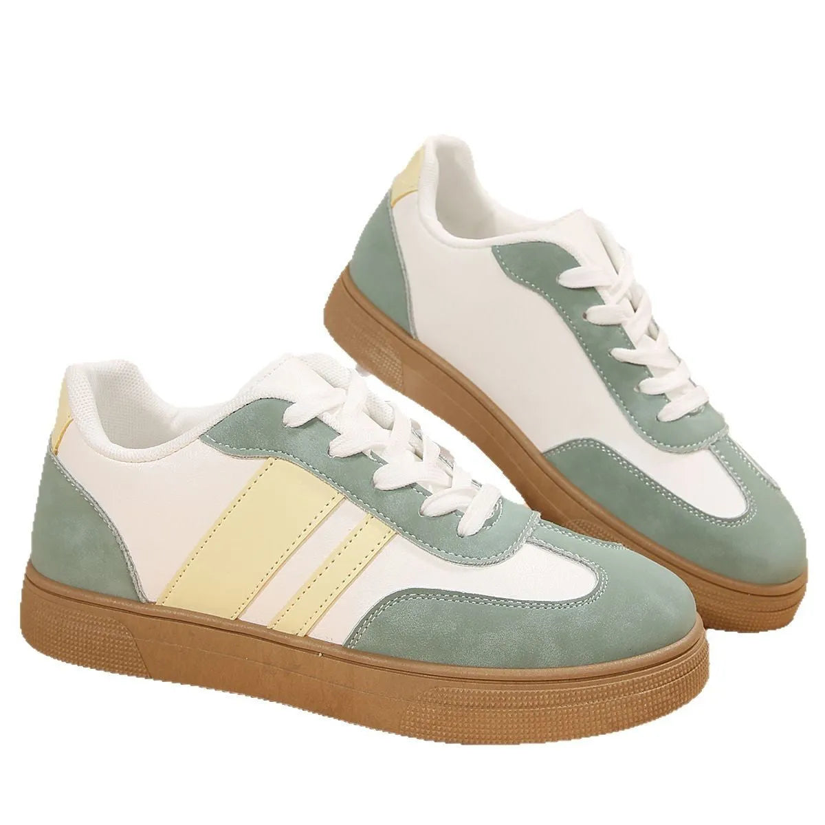 Green women's retro sports pumps with cross straps, leather stitching, and a round toe on a rubber sole.