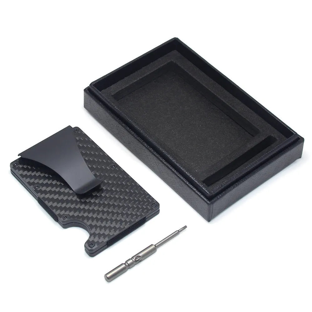 Slim black carbon fibre geometric wallet holding bank cards, showing 8mm thickness profile.