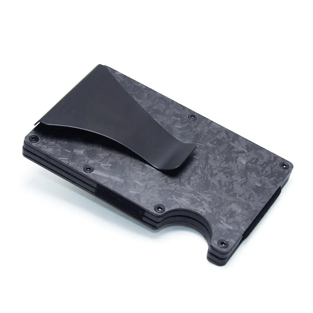 Slim black carbon fibre geometric wallet holding bank cards, showing 8mm thickness profile.