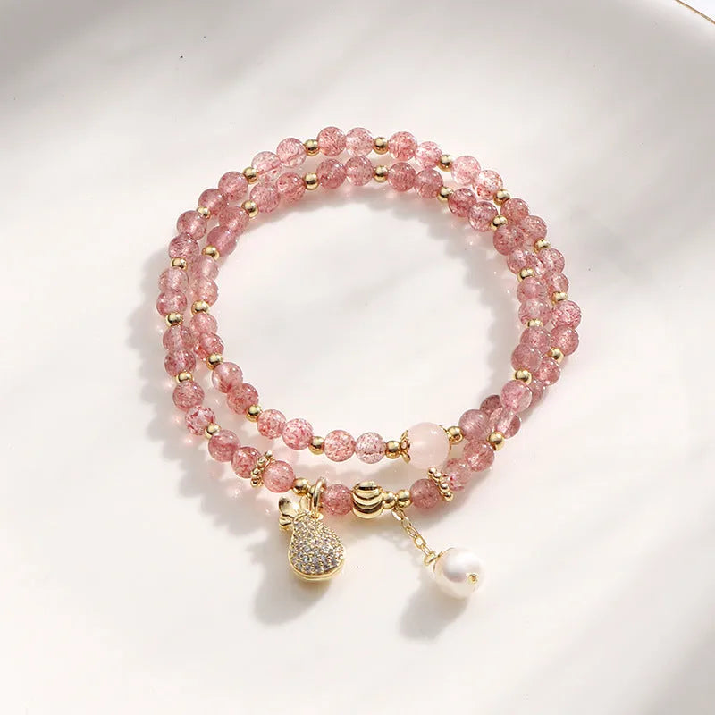 Geometric strawberry quartz crystal bracelet for women on a white background.