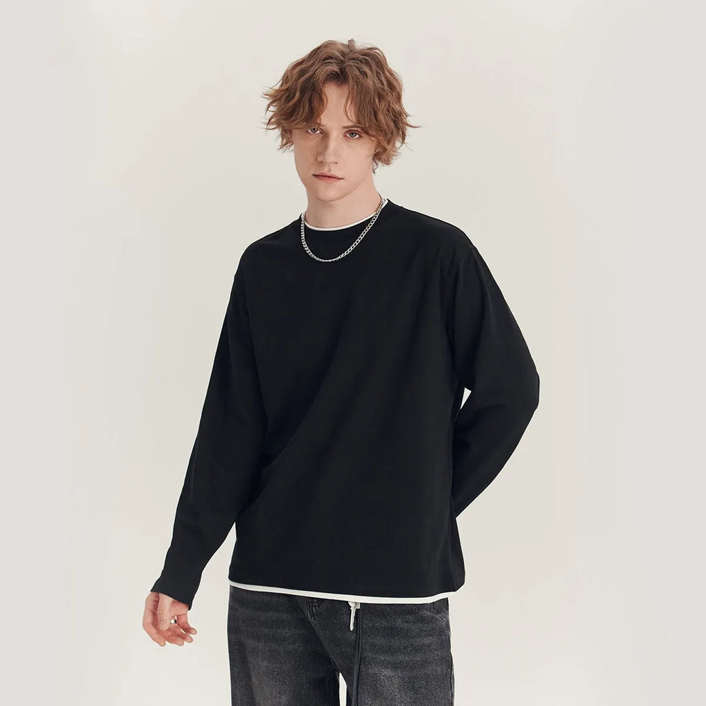 Man wearing a loose grey long-sleeved cotton blend T-shirt with a round neck.