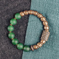 Retro ethnic style couples bracelet with green or red agate beads on a wrist.