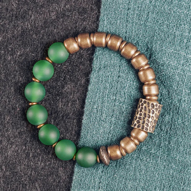 Retro ethnic style couples bracelet with green or red agate beads on a wrist.