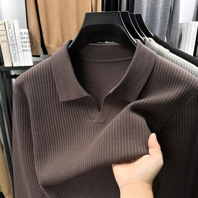 Man wearing a loose fit camel coloured casual pullover sweater.