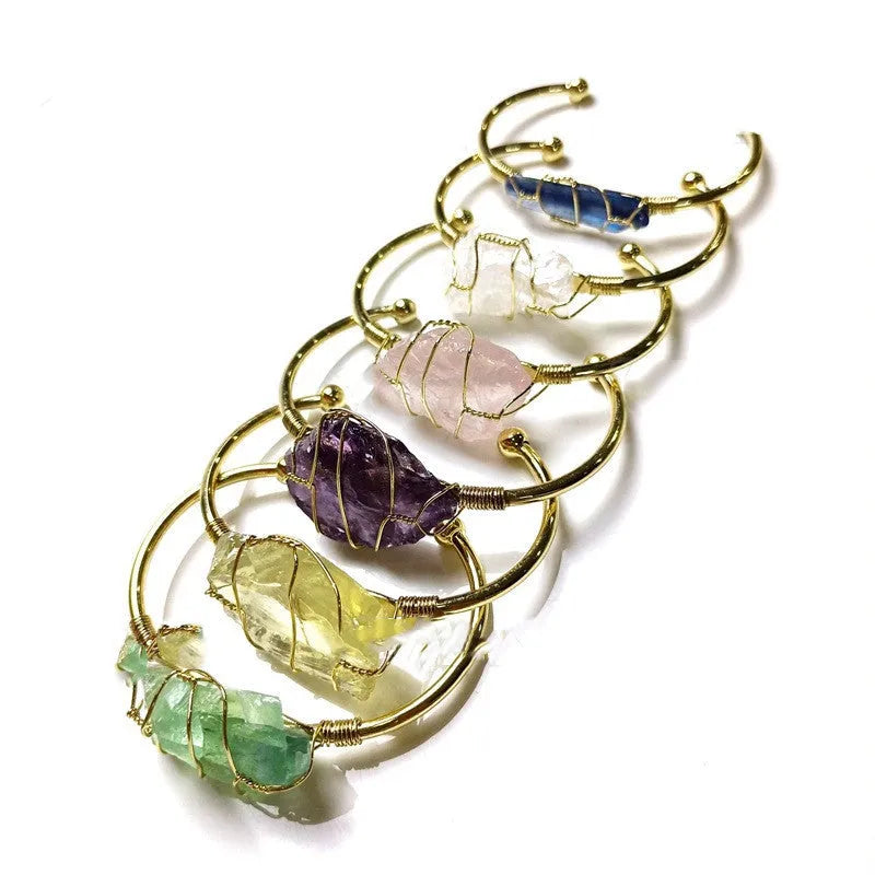 Unisex geometric bracelet made from rough natural crystals with gold metal winding.