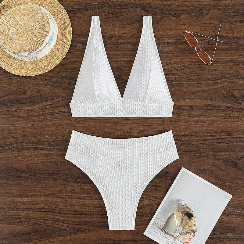 White backless bikini swimsuit with briefs bottom on a mannequin.