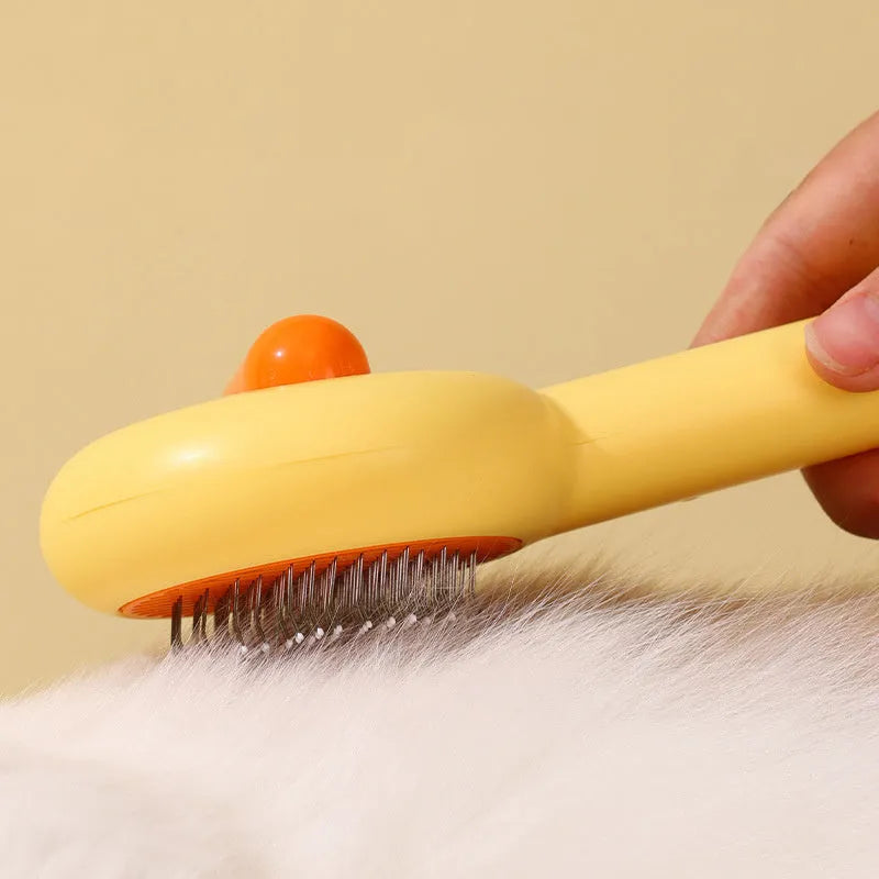 Small yellow duck-shaped pet comb with open needle design for cat and dog grooming