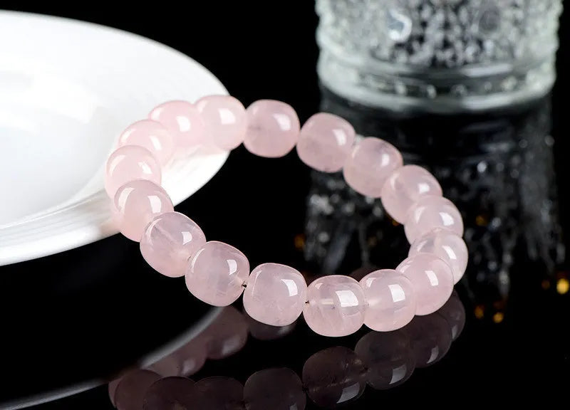 Pink bamboo crystal barrel bead bracelet with 11-12mm beads on a wrist.