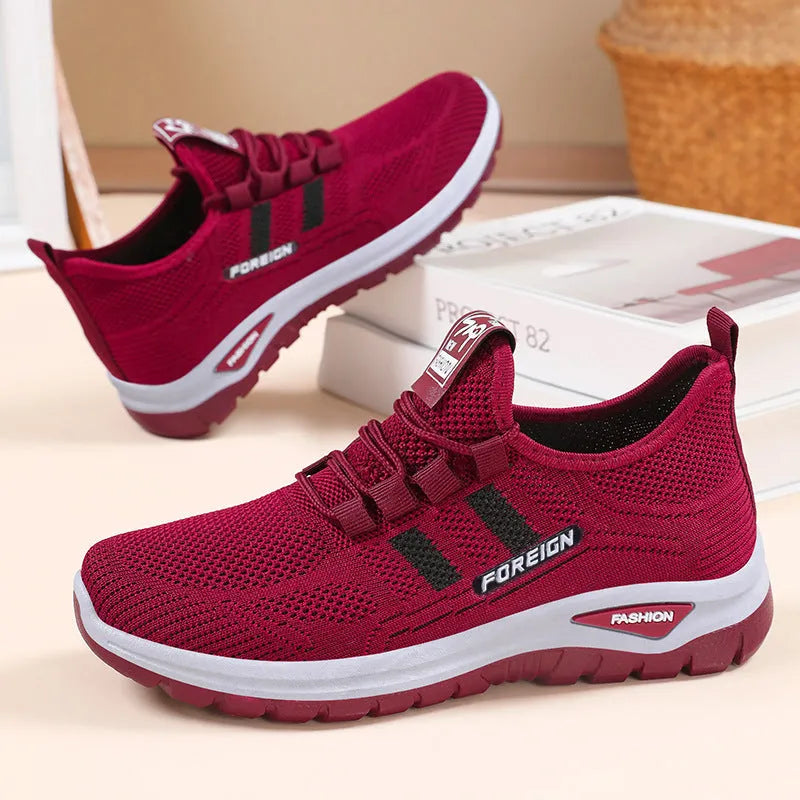 Women's low-top casual sneakers in black with breathable mesh upper and flat PVC sole