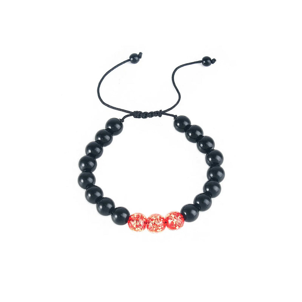 Adjustable luminous glass bead bracelet in geometric shapes on wrist showing elastic cord threading