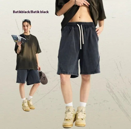 Man wearing batik pattern cotton terry shorts in a loose street fashion cut