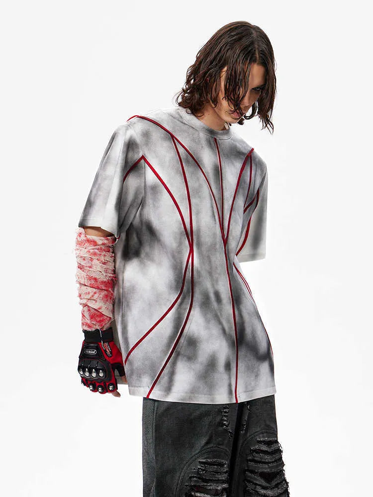 Women's short sleeve T-shirt with padded shoulders and textured line patchwork detail on a round neck.