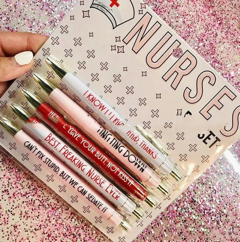 Five nurse-themed retractable ballpoint pens with humorous medical prints arranged together