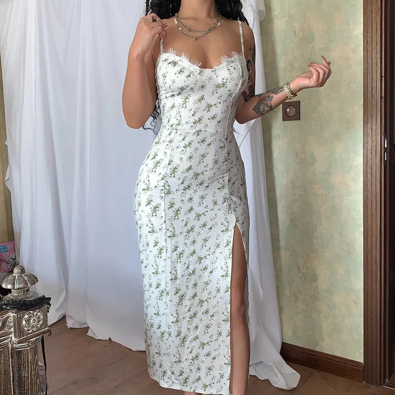 Blue women's long dress with white lace flower print, side slit, and thin suspender straps.