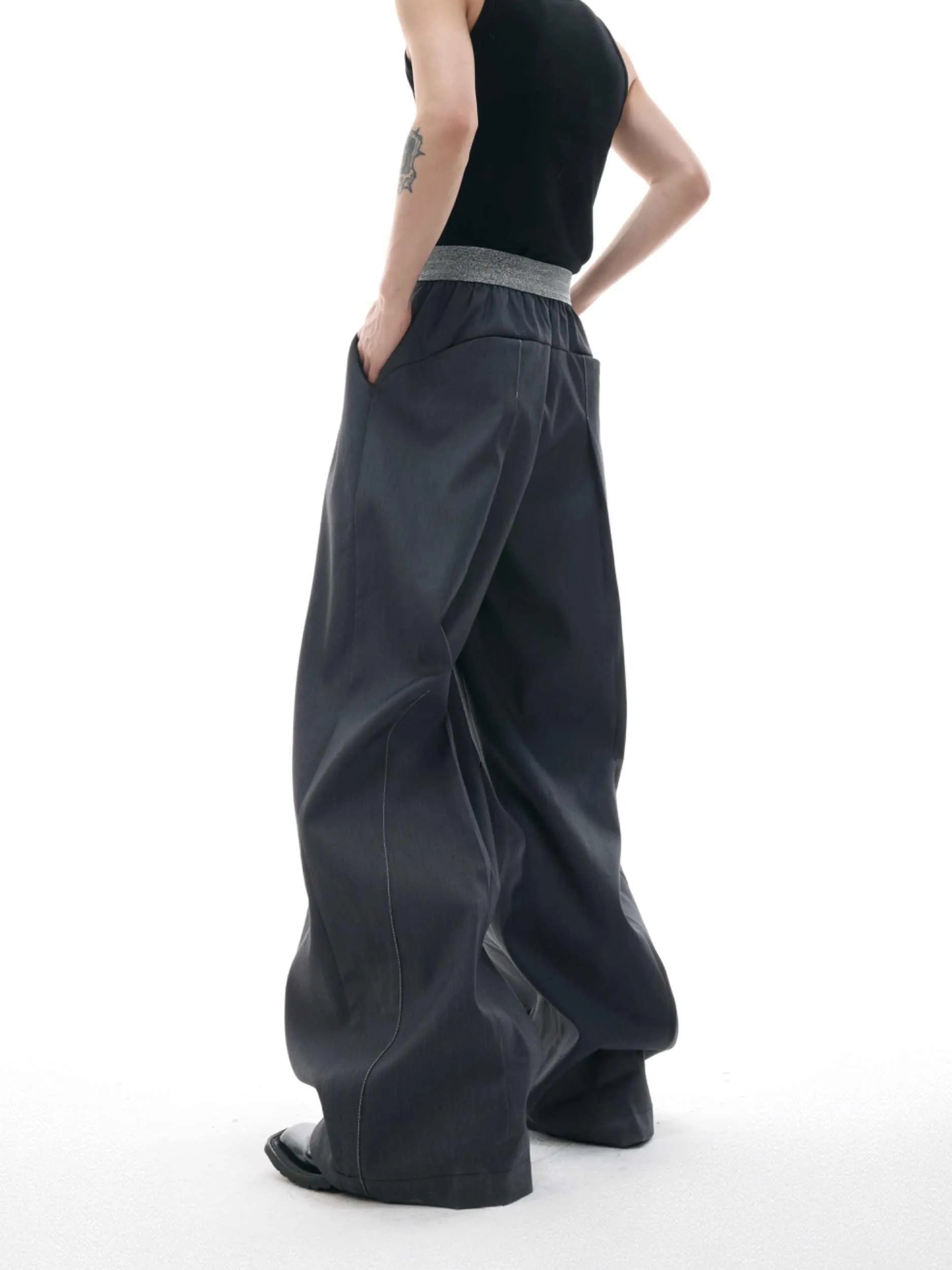 Straight-leg high-waisted casual trousers with a button-open front seam detail in black.