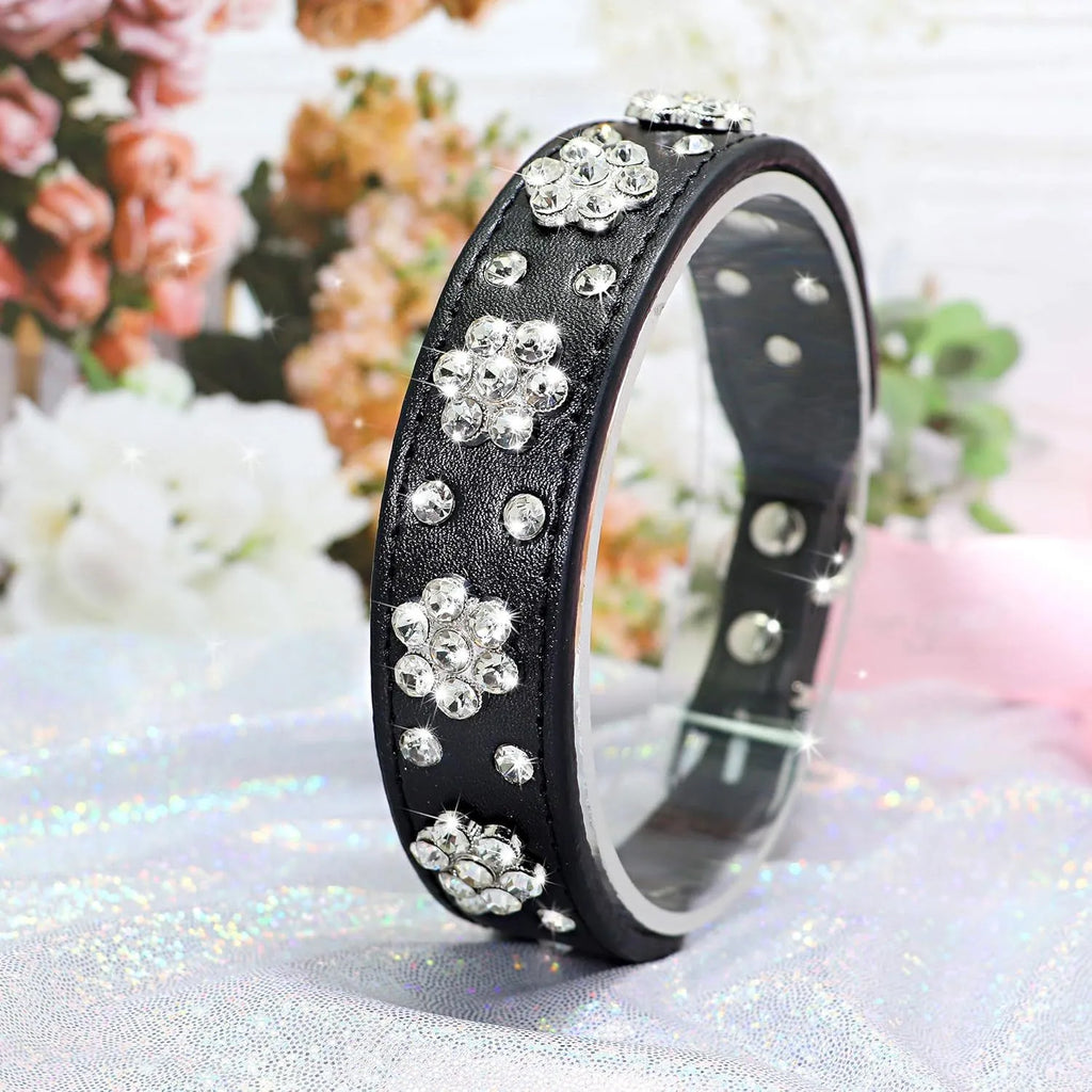 Black PU leather dog collar with rhinestone flower pattern and studs, adjustable for small dogs.