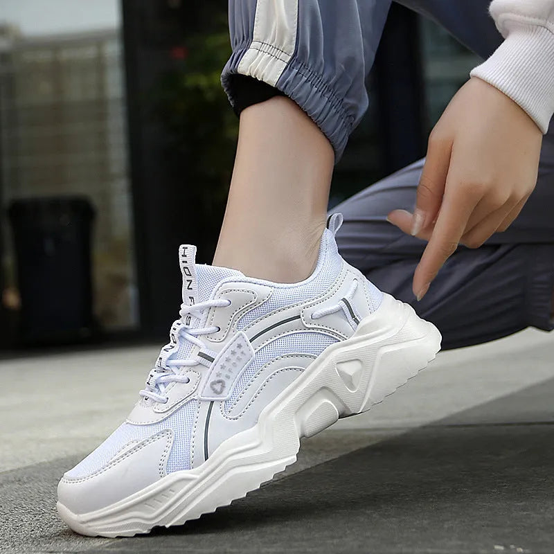 White women's casual sport shoes with a mesh upper, thick PU sole, buckle detail, and round toe.