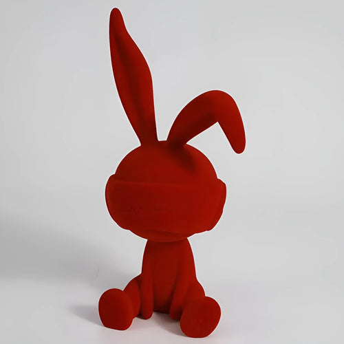 Green suede-finish resin ornament of a blindfolded rabbit for table decoration.
