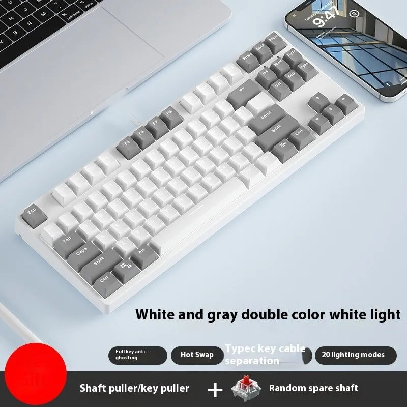 87-key wired mechanical keyboard with two-tone keycaps, shown with switch puller and cleaning brush