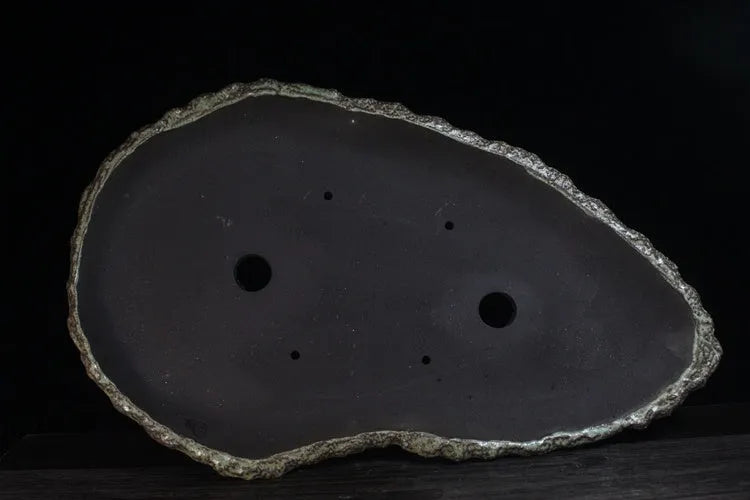 Handmade purple clay flower pot showing natural ceramic texture and floor-standing design