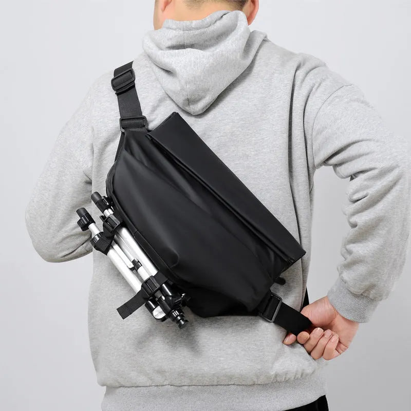 Grey PU leather men's crossbody sling backpack showing front zipper and shoulder strap.
