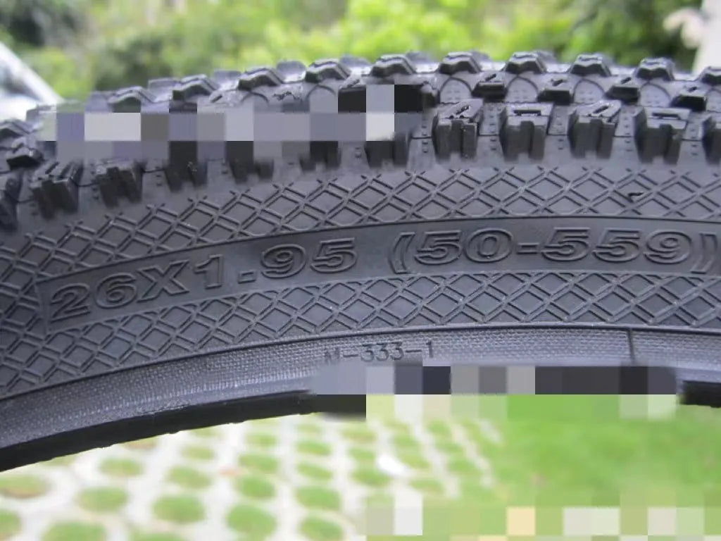 Ultralight mountain bike tyre with puncture-resistant tread, shown in a black and white sidewall style.