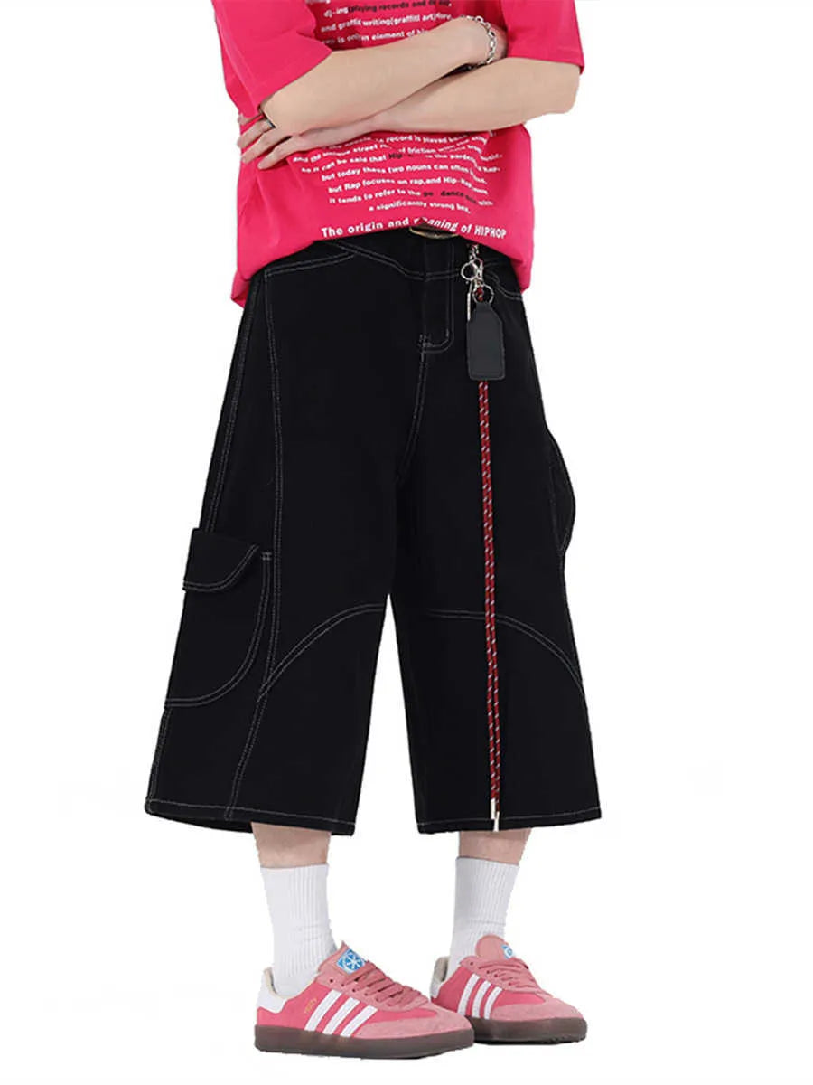 Red and black denim workwear shorts with multiple pockets, cropped length, and wide leg design