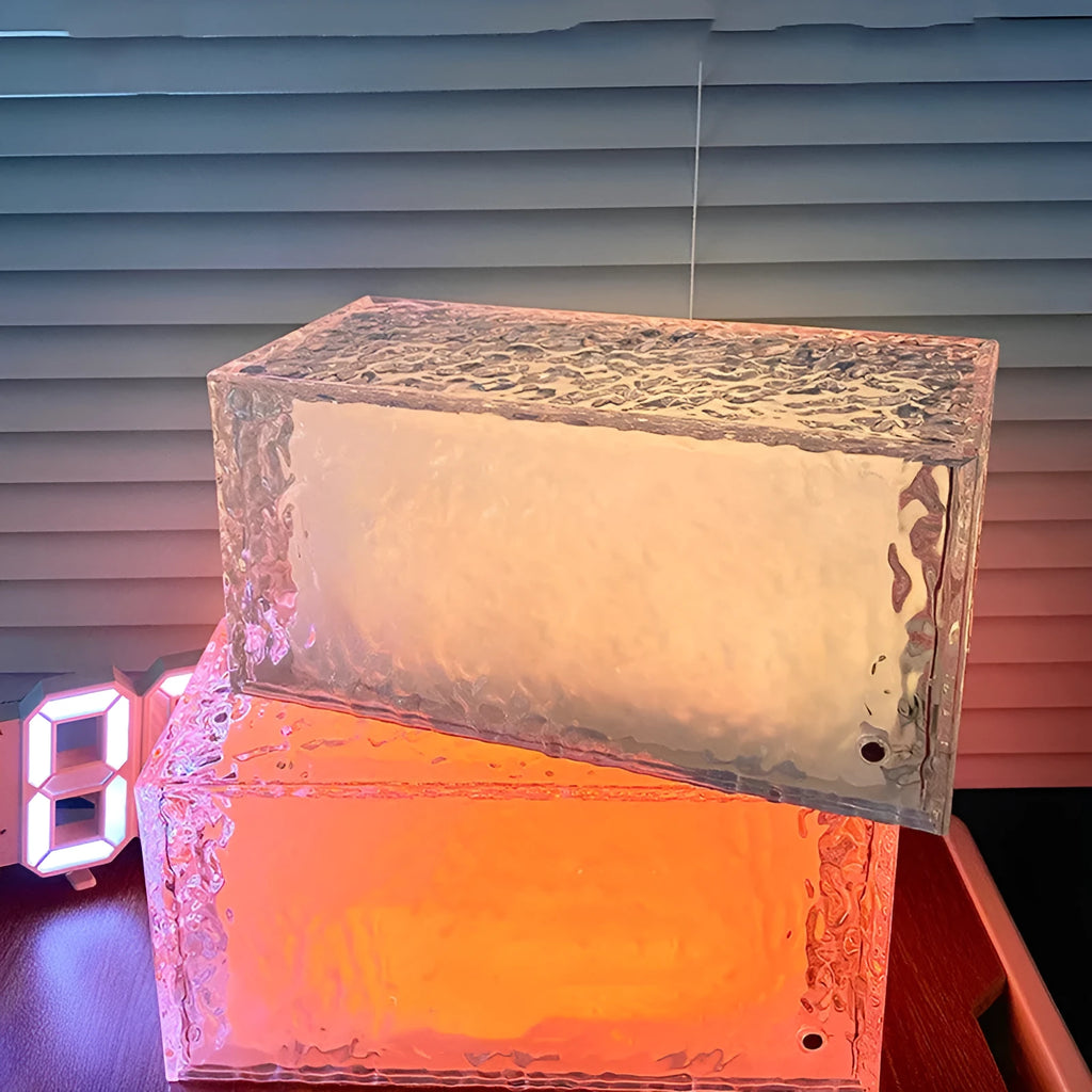 Clear acrylic geometric ice cube shaped night lamp glowing with soft colour changing light.